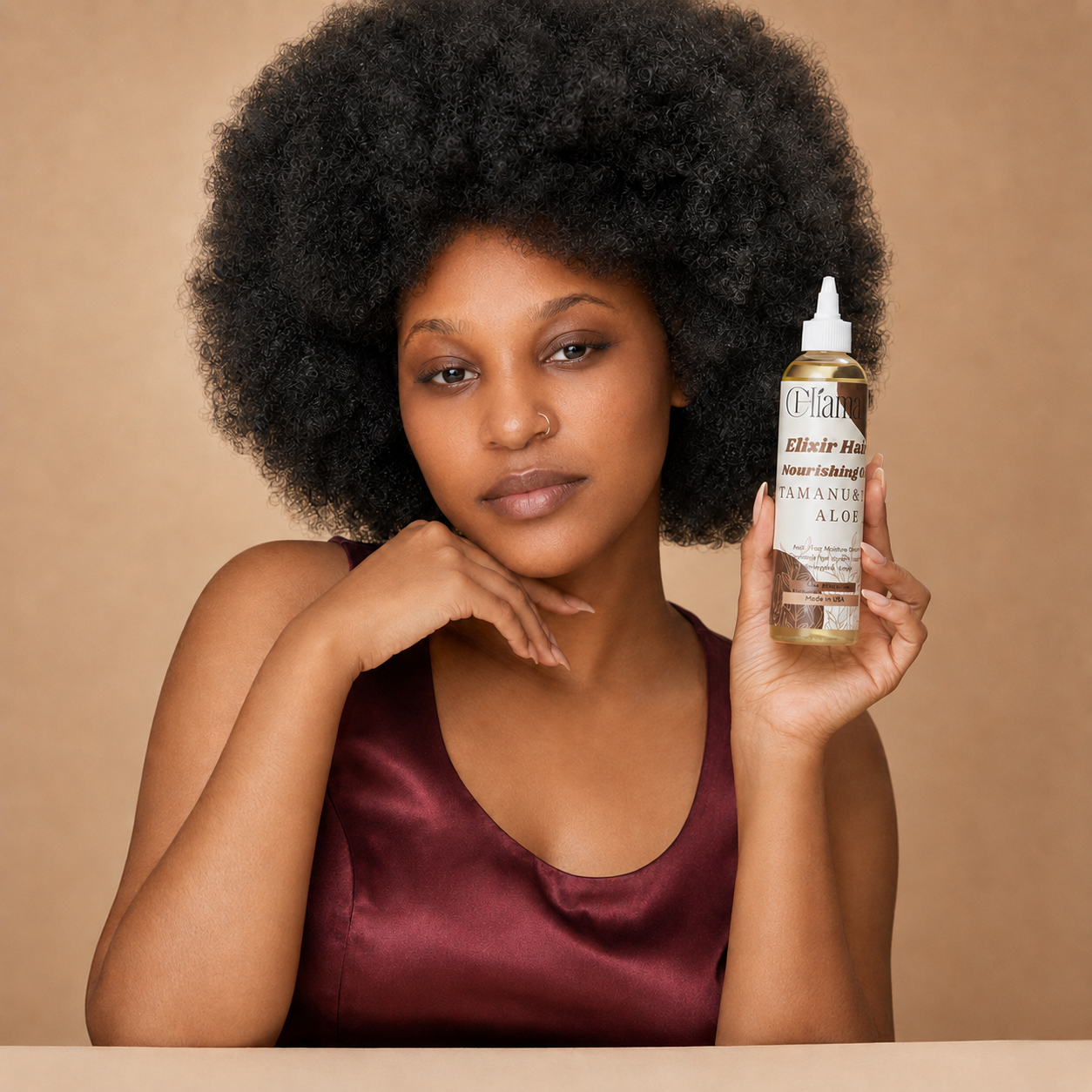 Woman applying Chiama Organics Scalp & Edge Oil with a dropper, demonstrating the correct method for oiling natural hair for natural hair growth.